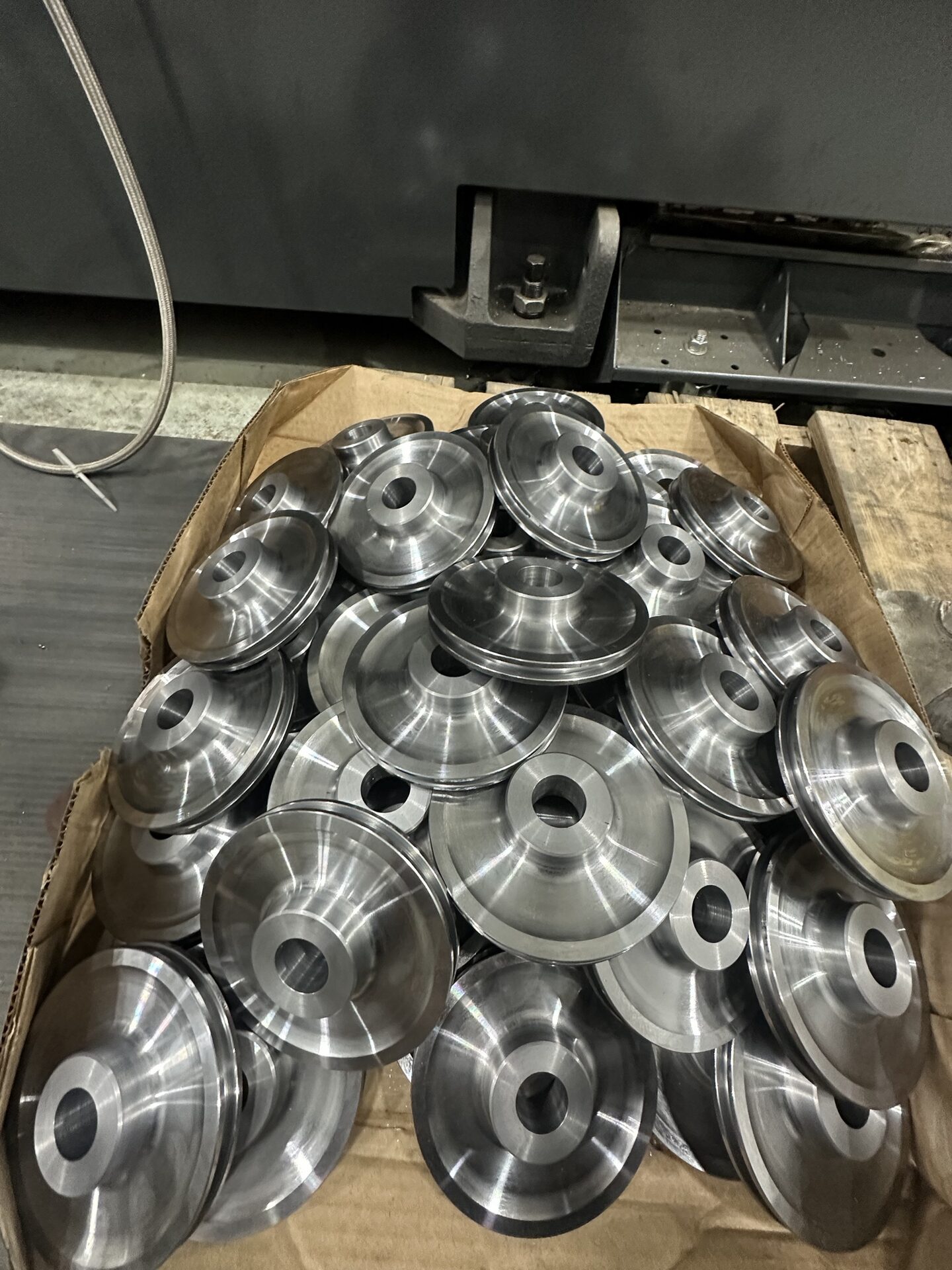 Freshly machined pulleys stacked ready for finishing.