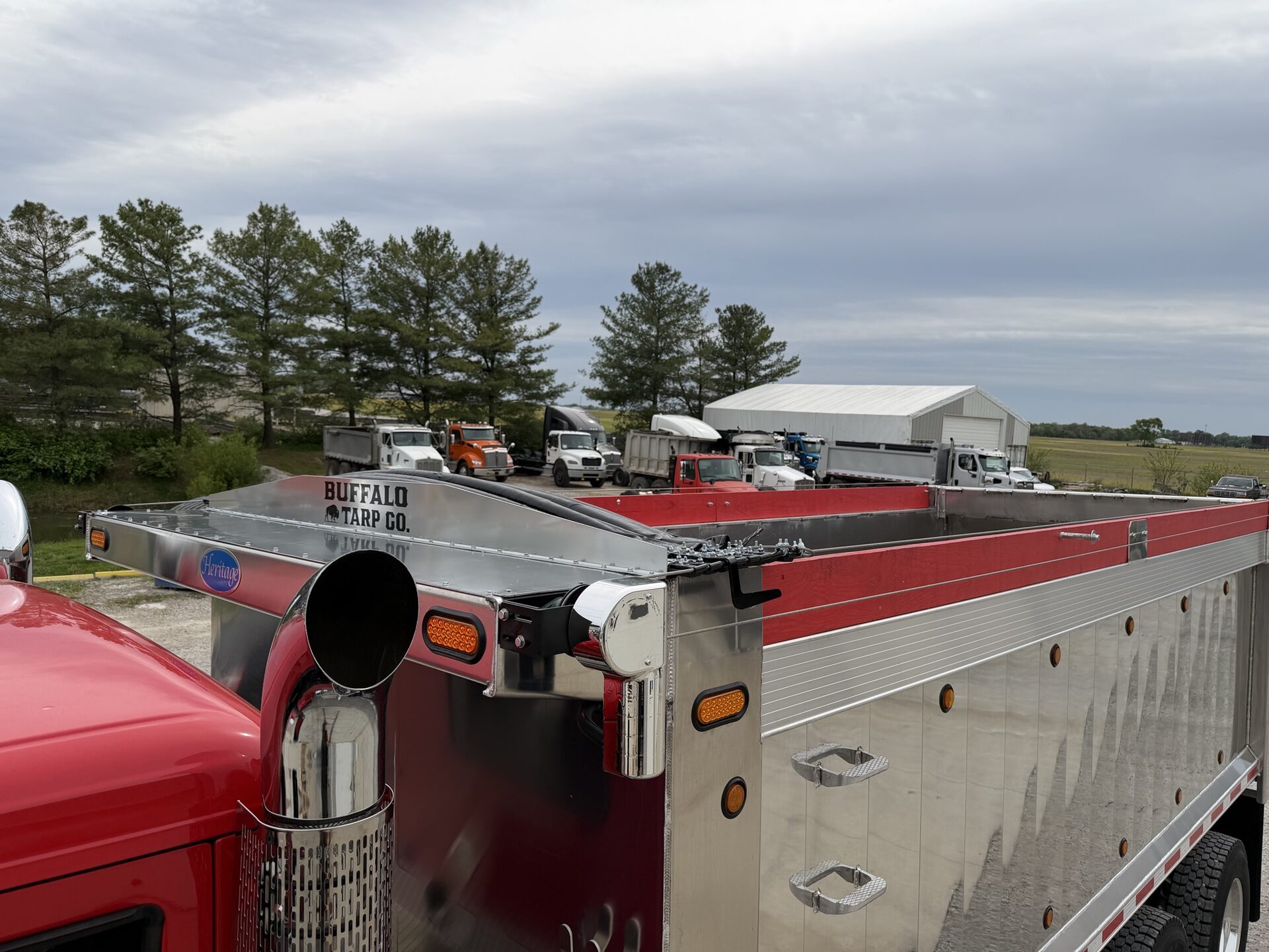Red truck with branded Buffalo Tarp head assembly.