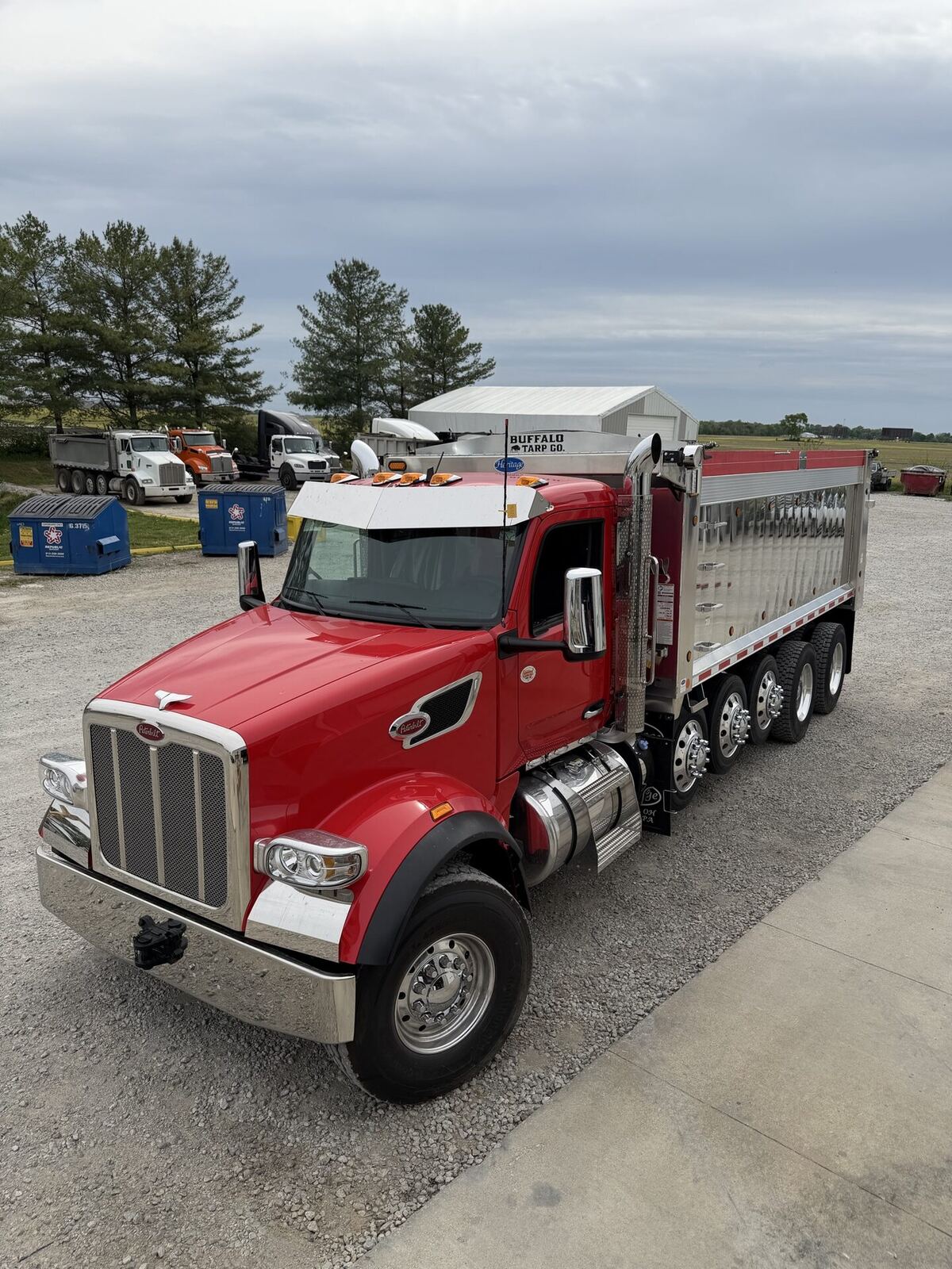Red Peterbilt dump truck with Buffalo Tarp system installed.