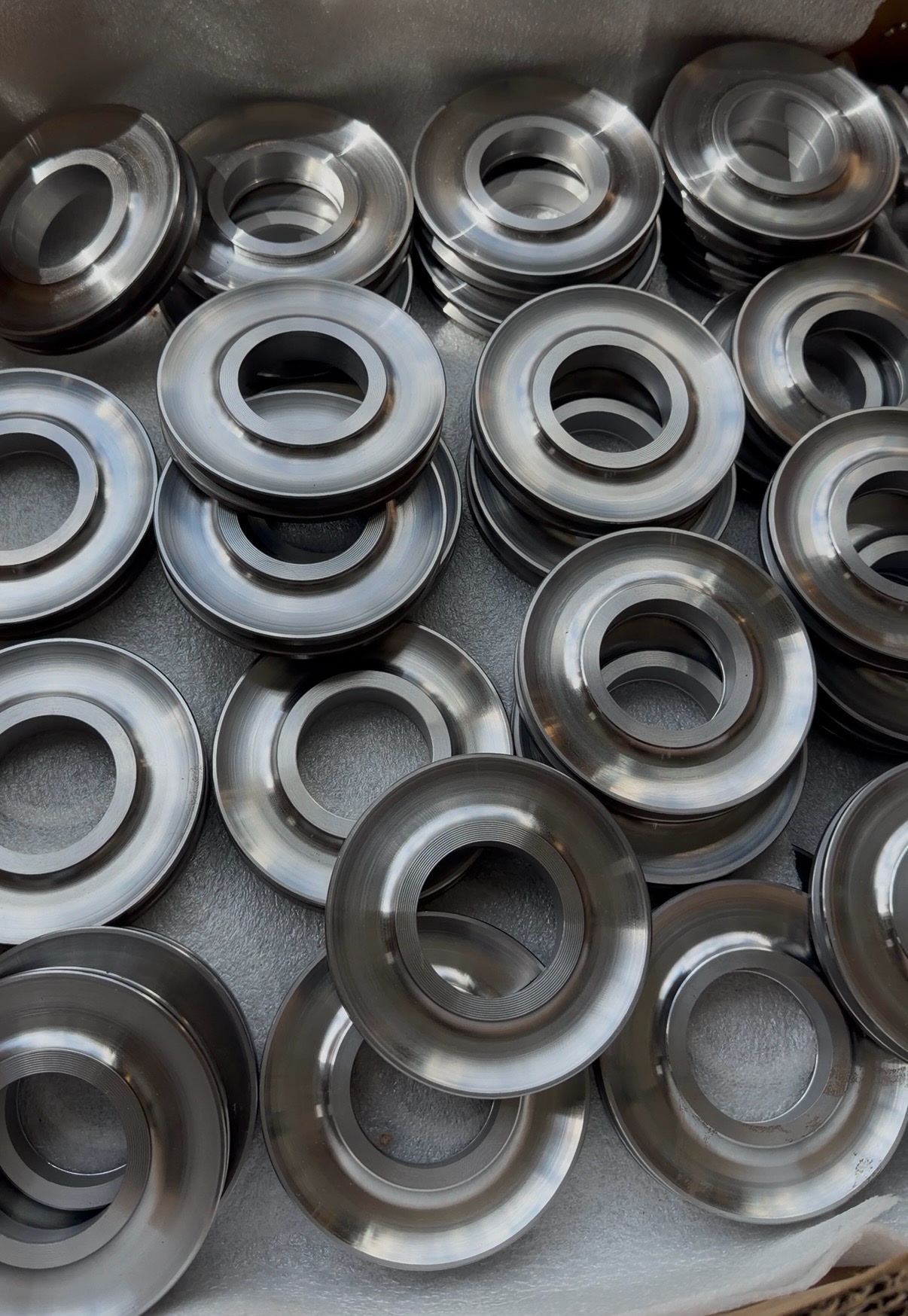 Precision-stamped steel rings staged after forming.