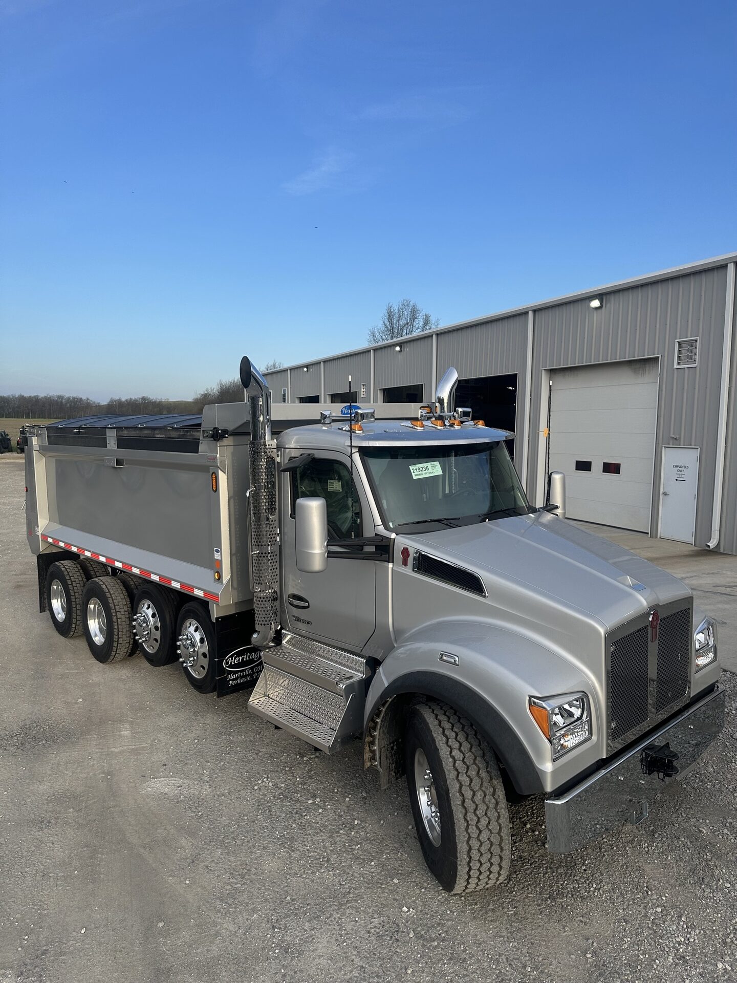 Silver Kenworth dump truck with Buffalo Tarp system.